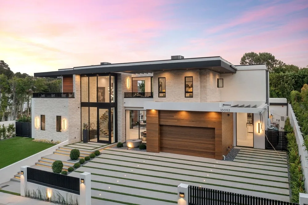 Wood-look flush garage door on a modern home at dusk